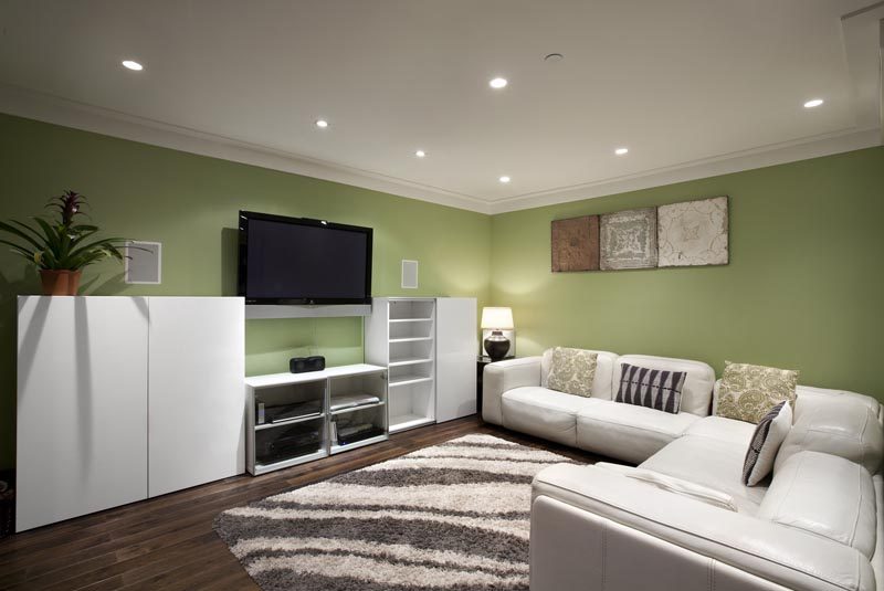 Living room with modern furniture, green walls, and hardwood floors. - 4104 West 12th Avenue, Vancouver West Side