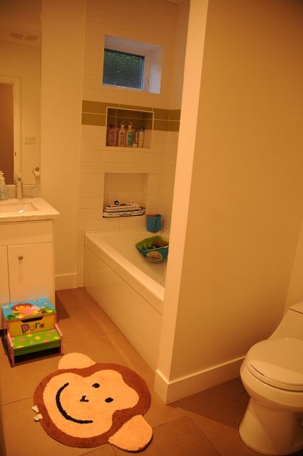 Bathroom with white fixtures, small window, and child-friendly decor. - 4104 West 12th Avenue, Vancouver West Side