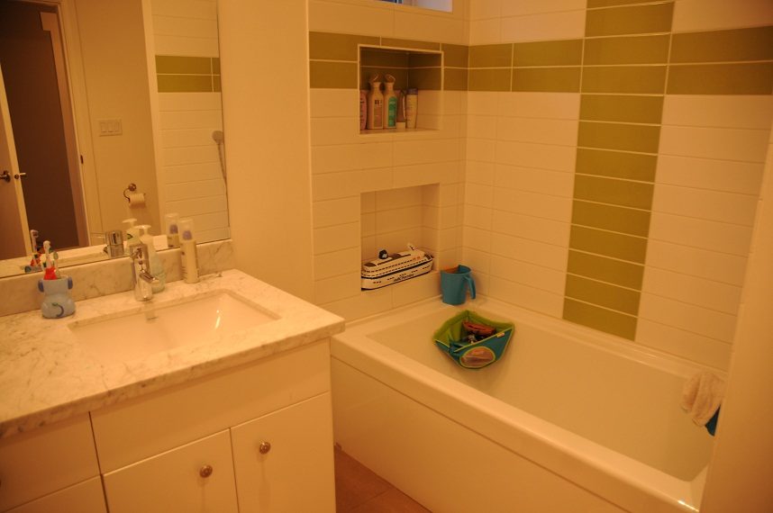 Bathroom with marble countertop and built-in shelving. - 4104 West 12th Avenue, Vancouver West Side