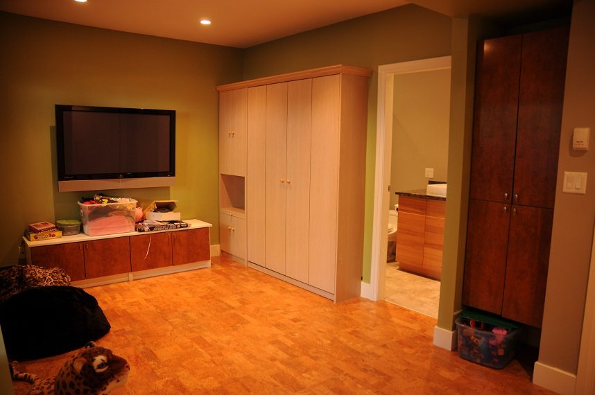 Living room with hardwood floors, built-in cabinets, and a flat-screen TV. - 4104 West 12th Avenue, Vancouver West Side
