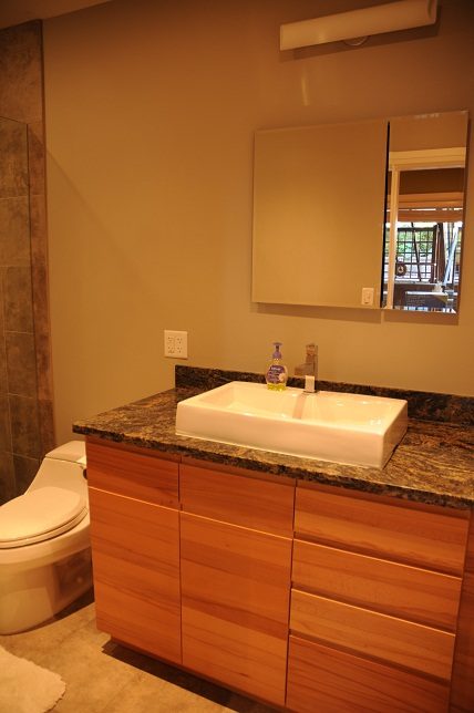 Bathroom with granite countertop and wooden cabinets. - 4104 West 12th Avenue, Vancouver West Side