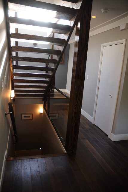 Furnished entryway with dark wood stairs and hardwood floors. - 4104 West 12th Avenue, Vancouver West Side