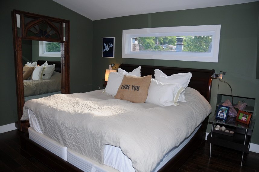 Spacious bedroom with dark green walls, large bed, and a window with a city view. - 4104 West 12th Avenue, Vancouver West Side