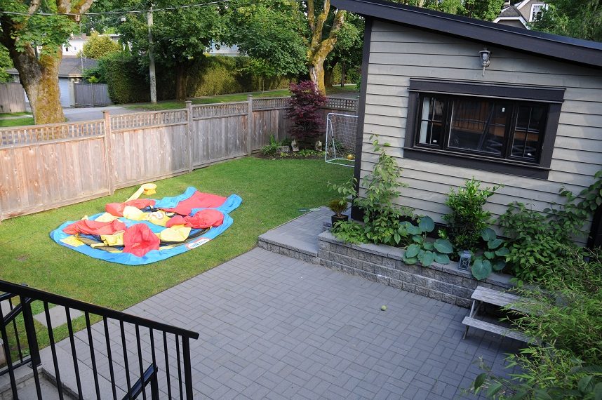 Fenced backyard with inflatable pool and patio area. - 4104 West 12th Avenue, Vancouver West Side