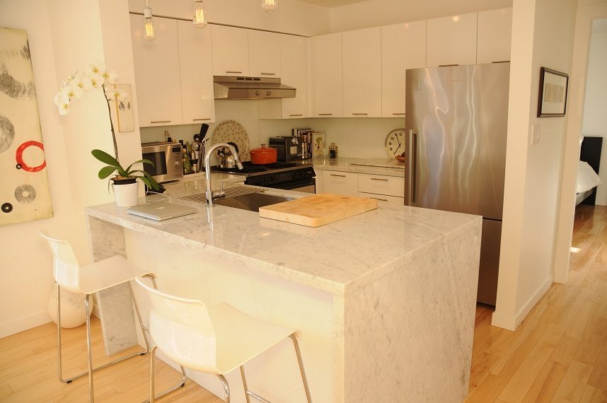 Bright kitchen with white marble countertops, hardwood floors, and stainless steel appliances. - 411- 2161 West 12th Avenue, Vancouver West Side