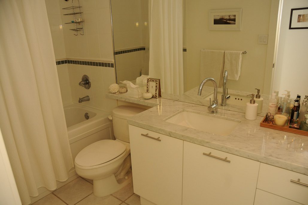 Bright bathroom with marble countertops and a modern sink setup. - 411- 2161 West 12th Avenue, Vancouver West Side