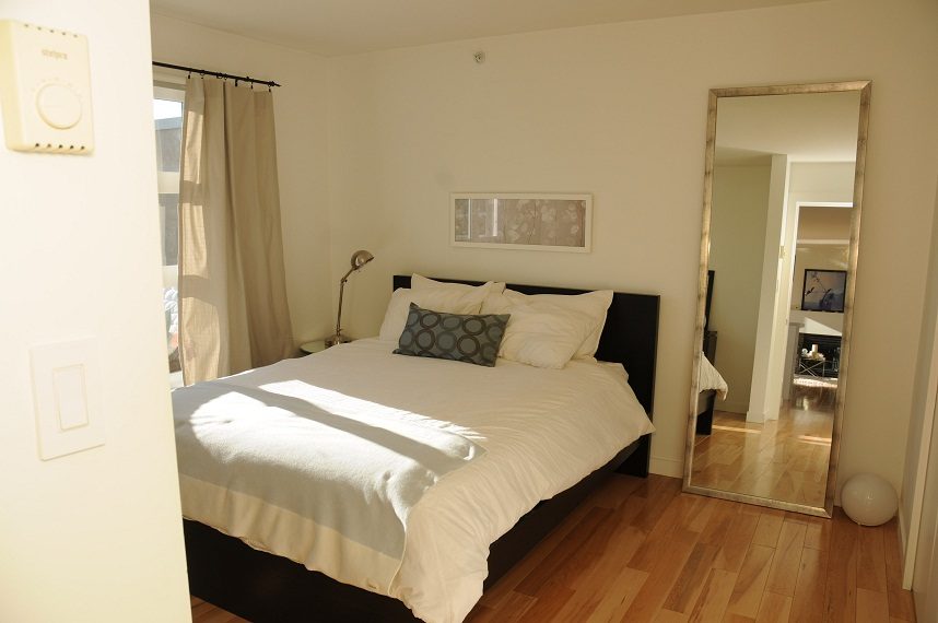 Bright bedroom with hardwood floors and a large mirror. - 411- 2161 West 12th Avenue, Vancouver West Side