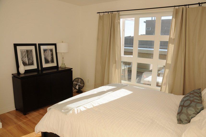 Bright bedroom with hardwood floors and a city view through large windows. - 411- 2161 West 12th Avenue, Vancouver West Side