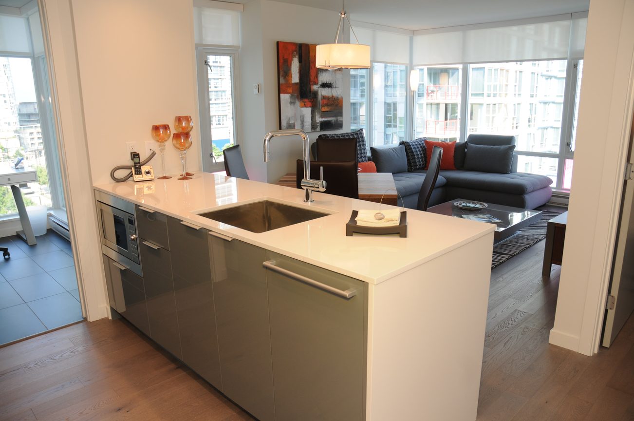 Bright kitchen with modern island, hardwood floors, city view, and a cozy living area. - 801 - 161 West Georgia, Vancouver Downtown