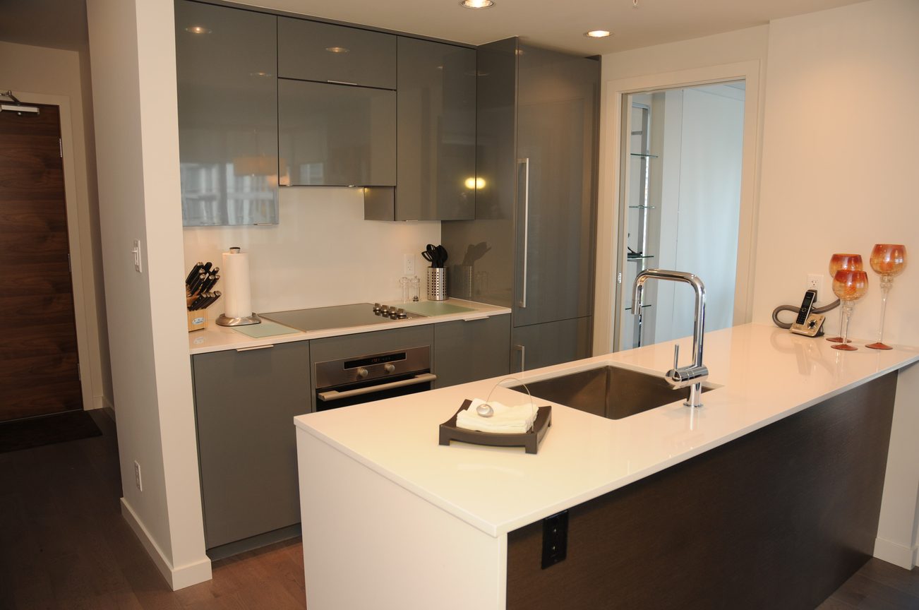 Bright kitchen with white countertops, dark cabinetry, and a modern faucet. - 801 - 161 West Georgia, Vancouver Downtown