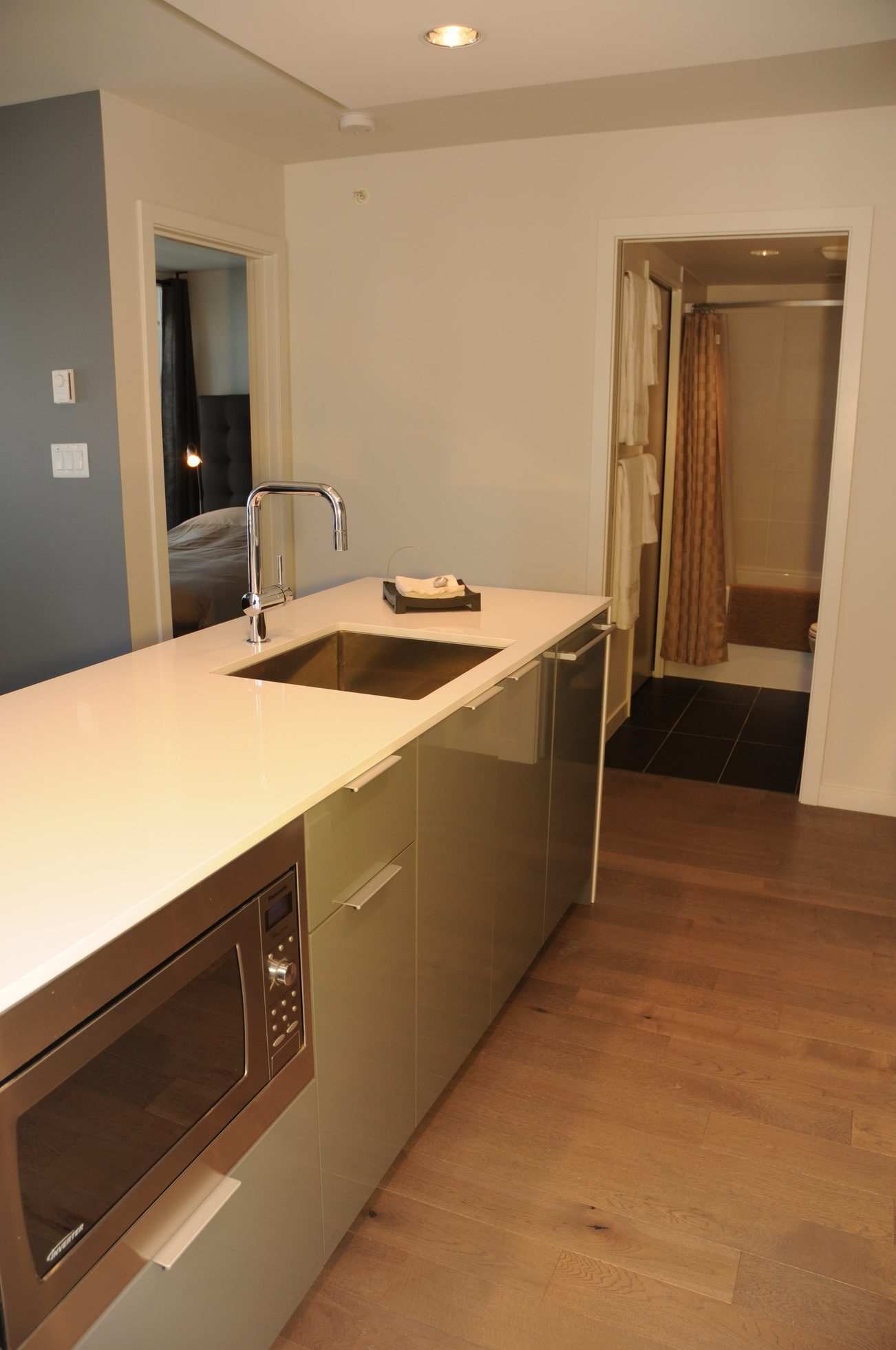 Bright kitchen with white countertops, stainless steel sink, and hardwood floors. - 801 - 161 West Georgia, Vancouver Downtown
