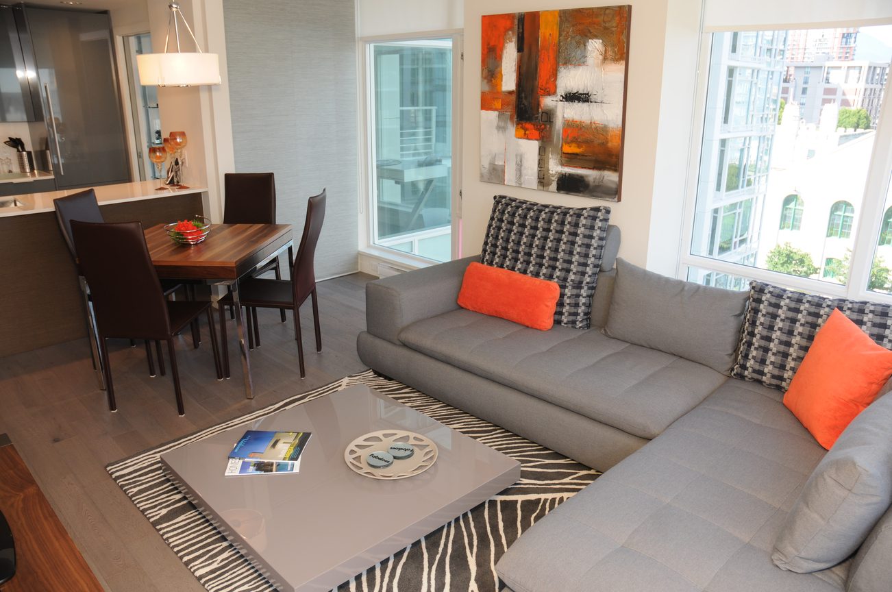 Furnished living room with modern furniture, city view, hardwood floors, and a zebra-patterned rug. - 801 - 161 West Georgia, Vancouver Downtown