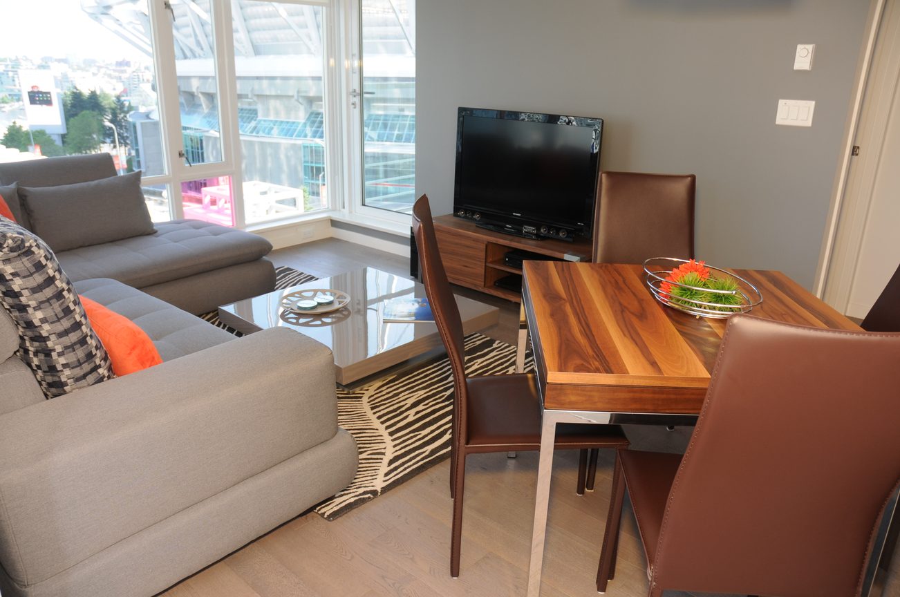 Furnished living and dining area with hardwood floors, city view, and modern furniture. - 801 - 161 West Georgia, Vancouver Downtown