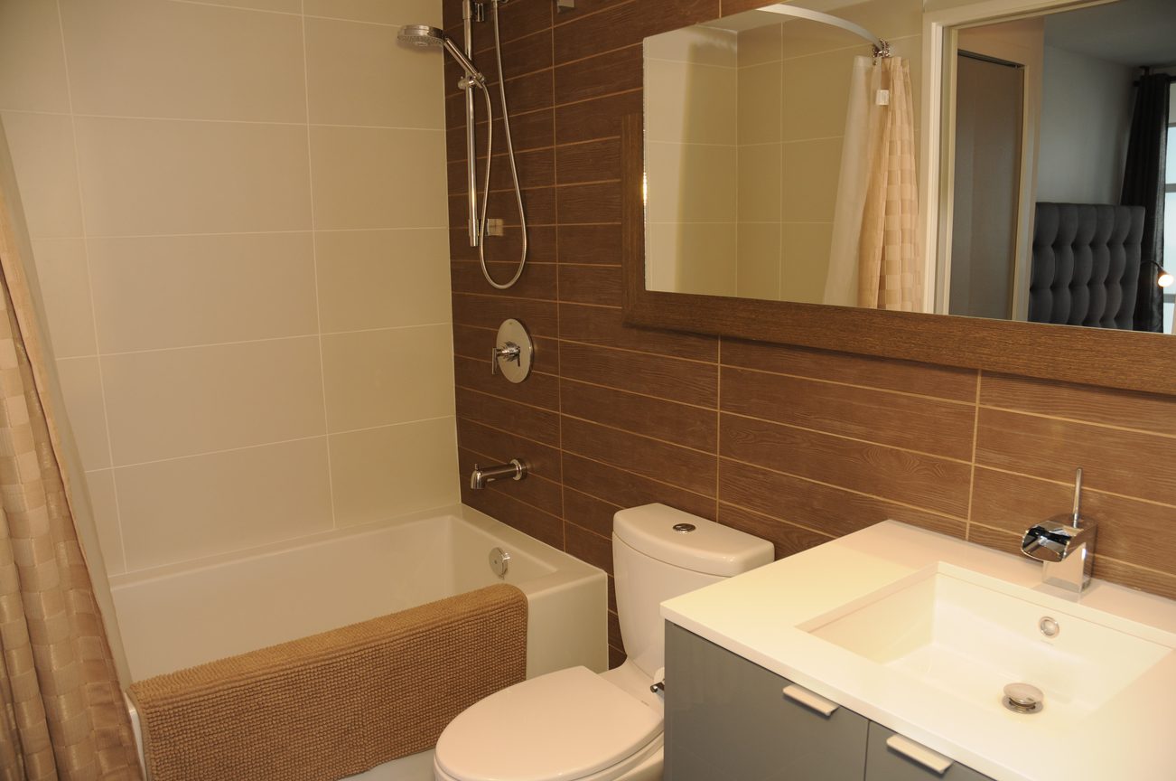Furnished bathroom with modern fixtures, wood paneling, and a large mirror. - 801 - 161 West Georgia, Vancouver Downtown
