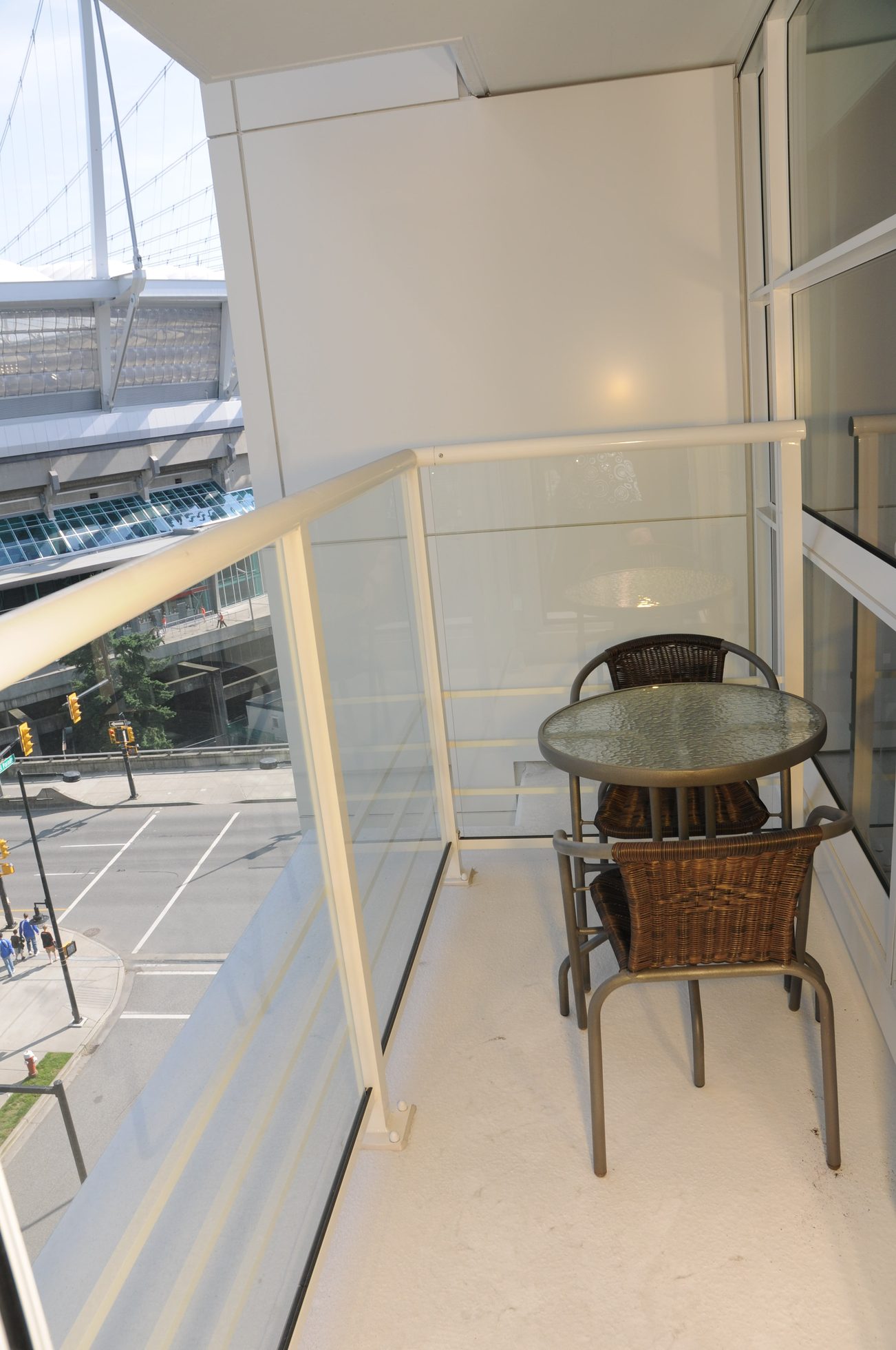 Furnished balcony with glass railing and city view. - 801 - 161 West Georgia, Vancouver Downtown