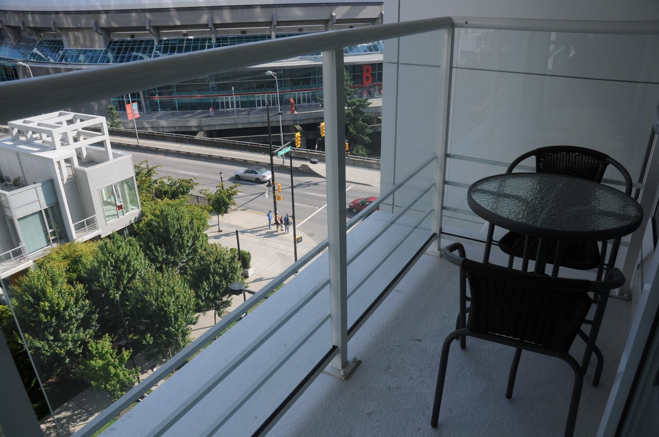 Balcony with glass railing, city view, and outdoor seating. - 801 - 161 West Georgia, Vancouver Downtown