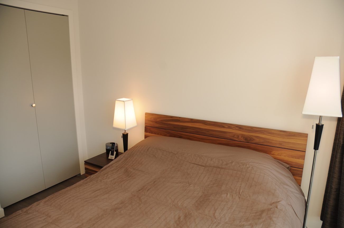 Furnished 1-bedroom + den with wooden headboard and bedside lamps. - 2009 - 161 West Georgia, Vancouver Downtown
