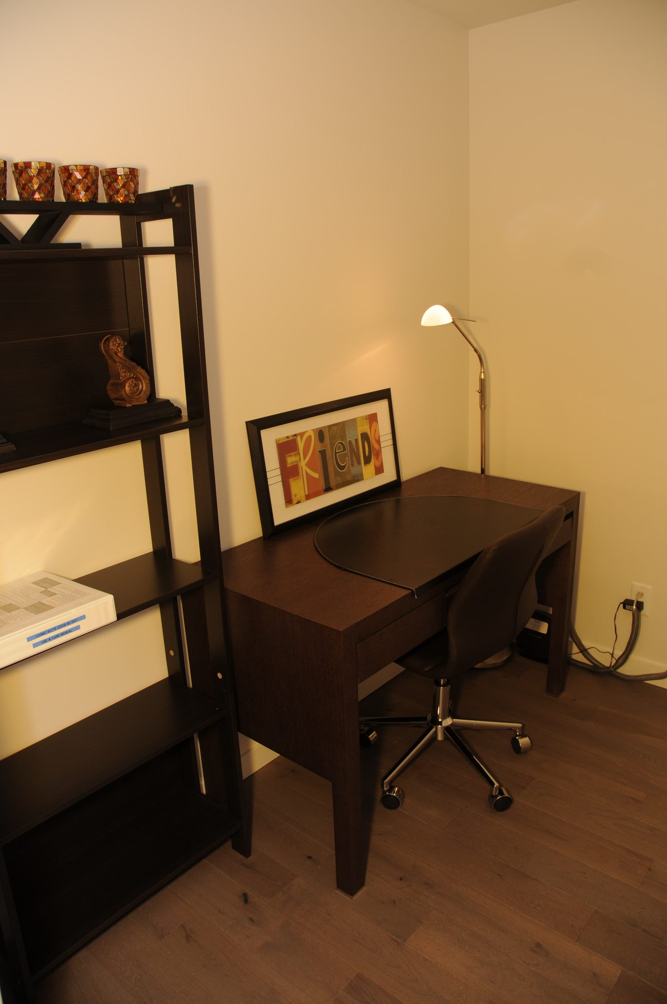 Furnished office with dark wood desk, rolling chair, and framed "Friends" artwork. - 2009 - 161 West Georgia, Vancouver Downtown