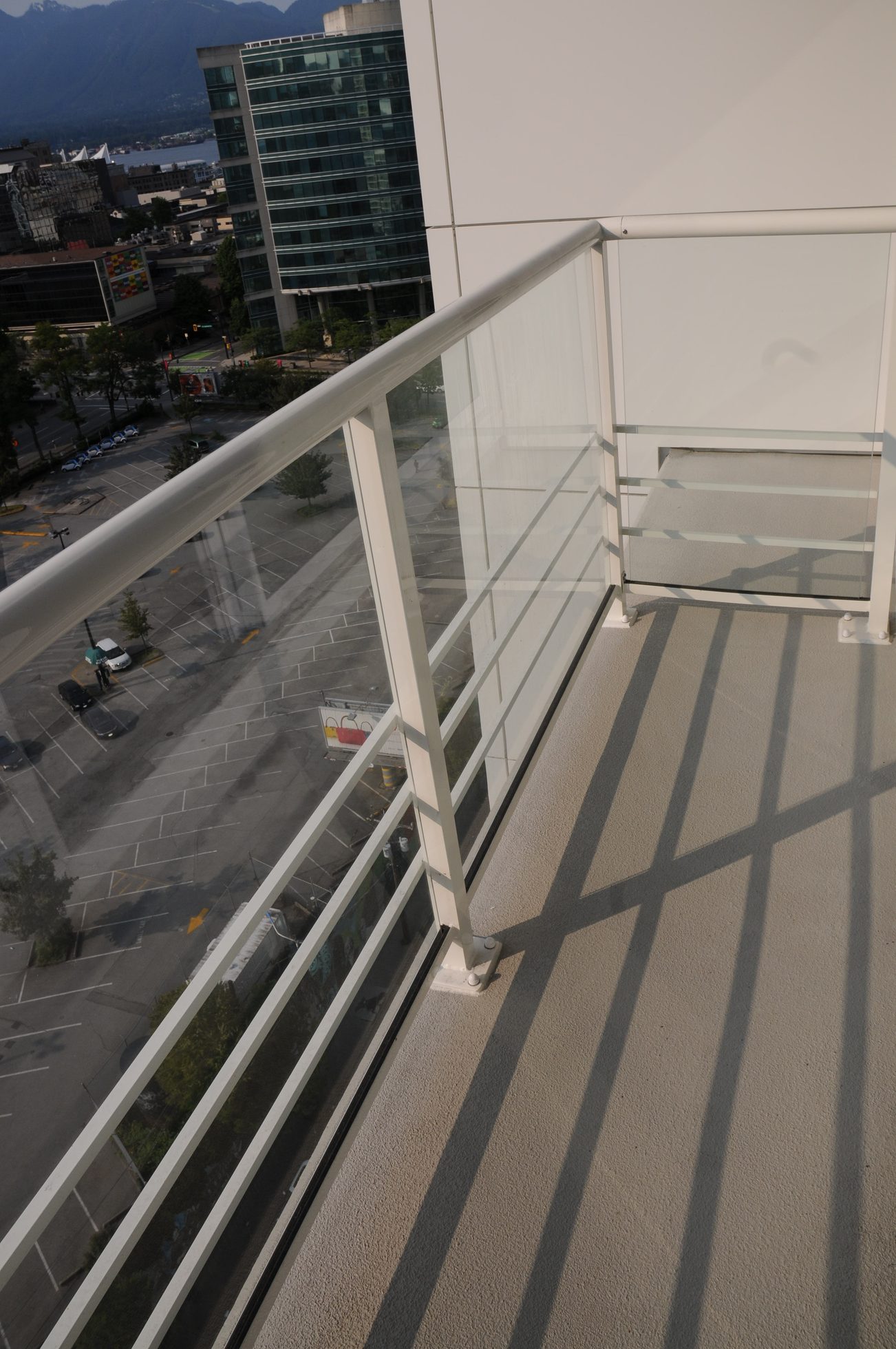 Balcony with glass railing, city view, modern design. - 2009 - 161 West Georgia, Vancouver Downtown
