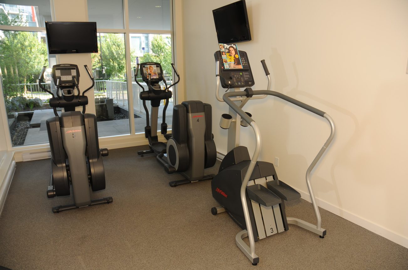 Bright fitness room with cardio machines and city view. - 2201 - 161 West Georgia, Vancouver Downtown