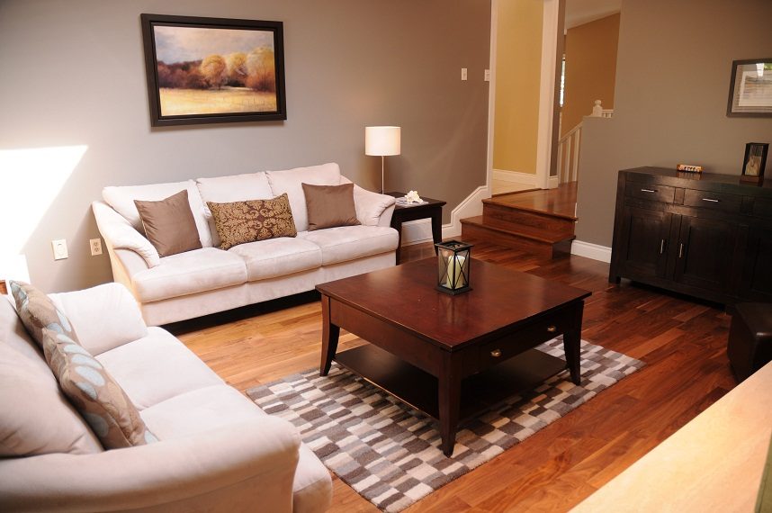 Furnished living room with hardwood floors, a coffee table, and a sofa set. - 5591 Huckleberry Place, North Vancouver
