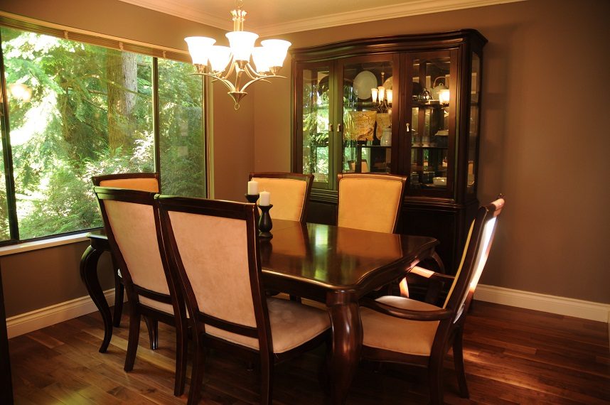 Formal dining room with hardwood floors, large windows, and a china cabinet. - 5591 Huckleberry Place, North Vancouver