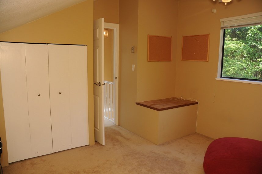Den with white closet, cork boards, and window view of trees. - 5591 Huckleberry Place, North Vancouver