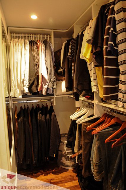 Furnished closet with neatly arranged clothing and hangers. - 1802- 2055 Pendrell, Vancouver Downtown
