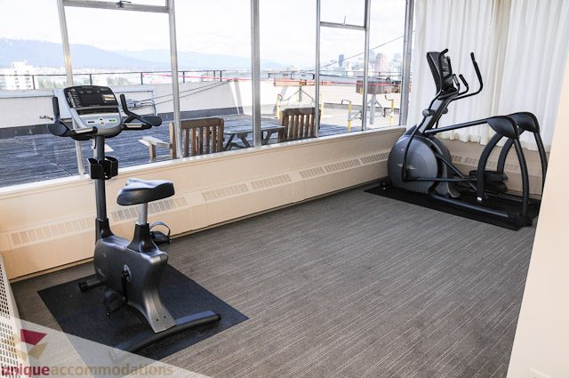 Bright living room with city view and modern furniture. - 1802- 2055 Pendrell, Vancouver Downtown