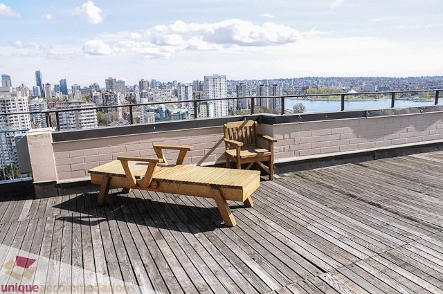 Furnished balcony with wooden furniture and city view. - 1802- 2055 Pendrell, Vancouver Downtown