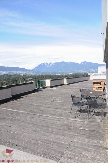 Furnished balcony with wooden flooring and city view. - 1802- 2055 Pendrell, Vancouver Downtown