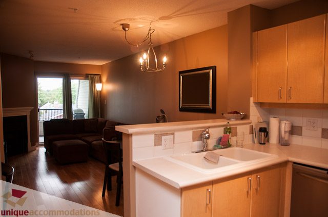 Bright kitchen with light wood cabinets and granite countertops, hardwood floors, and a city view. - 402- 2680 West 4th Ave PH2, Vancouver West Side