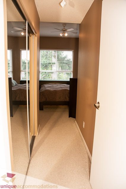 Bright bedroom with sliding closet doors and a window view. - 402- 2680 West 4th Ave PH2, Vancouver West Side