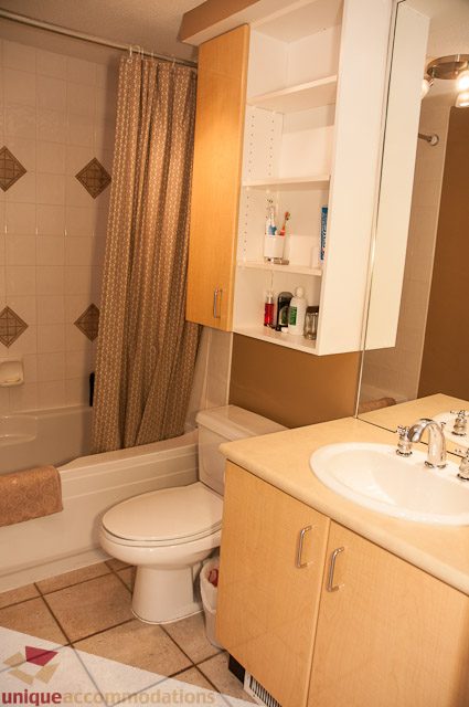 Furnished bathroom with light wood cabinets and a beige countertop. - 402- 2680 West 4th Ave PH2, Vancouver West Side