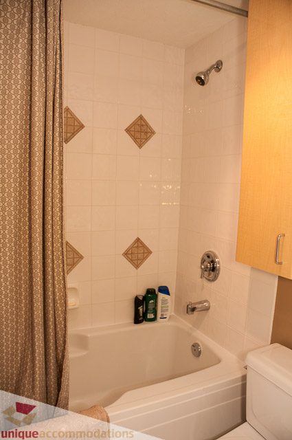 Bright bathroom with white tiles and decorative diamond patterns. - 402- 2680 West 4th Ave PH2, Vancouver West Side