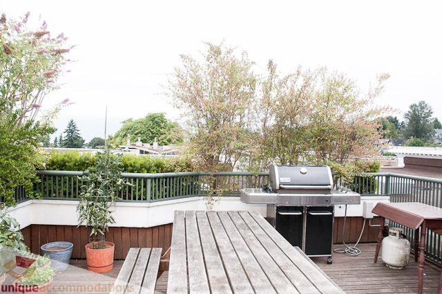 Furnished patio with wooden deck, plants, and grill. - 402- 2680 West 4th Ave PH2, Vancouver West Side