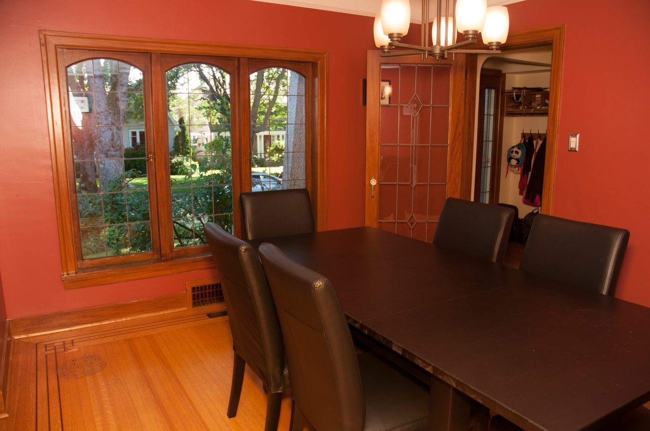 Furnished dining room with hardwood floors and large windows offering a view of the neighborhood. - 3249 West 36th Ave, Vancouver West Side
