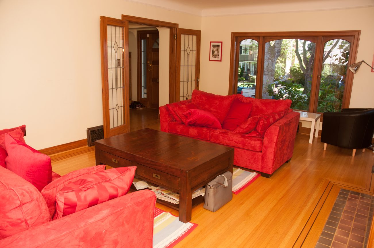 Bright living room with red furniture and hardwood floors. - 3249 West 36th Ave, Vancouver West Side
