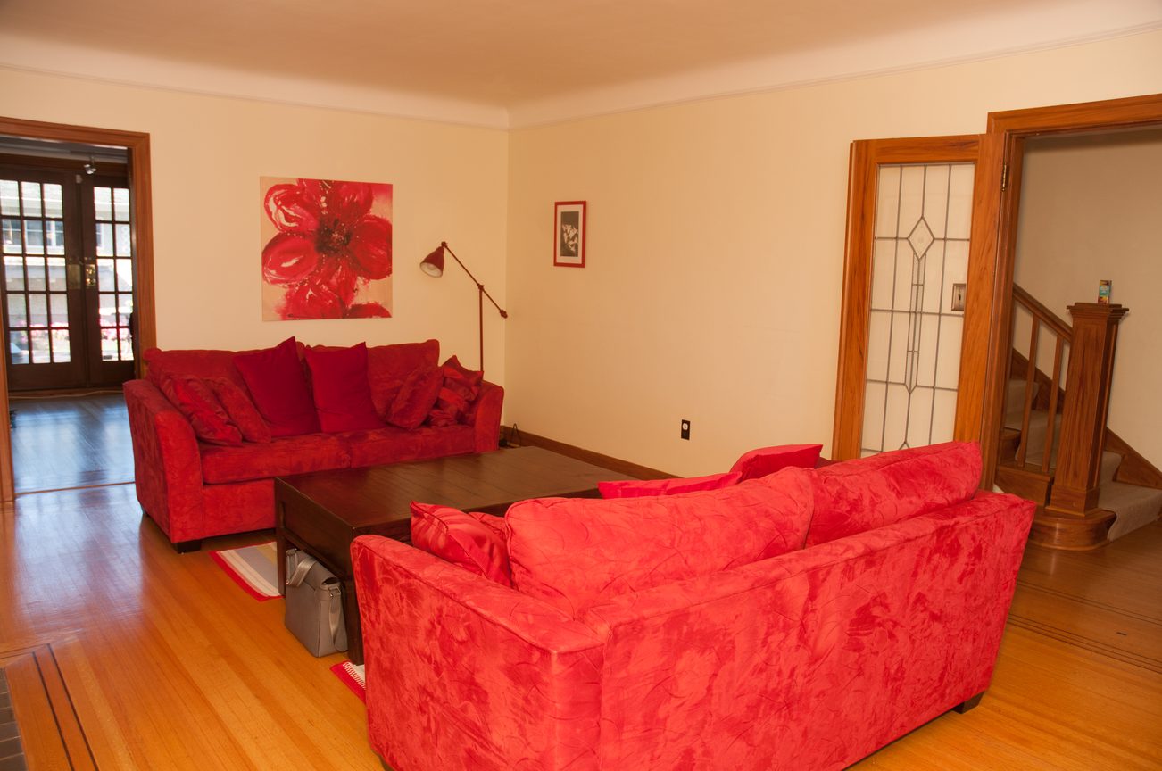 Living room with red furniture and hardwood floors. - 3249 West 36th Ave, Vancouver West Side