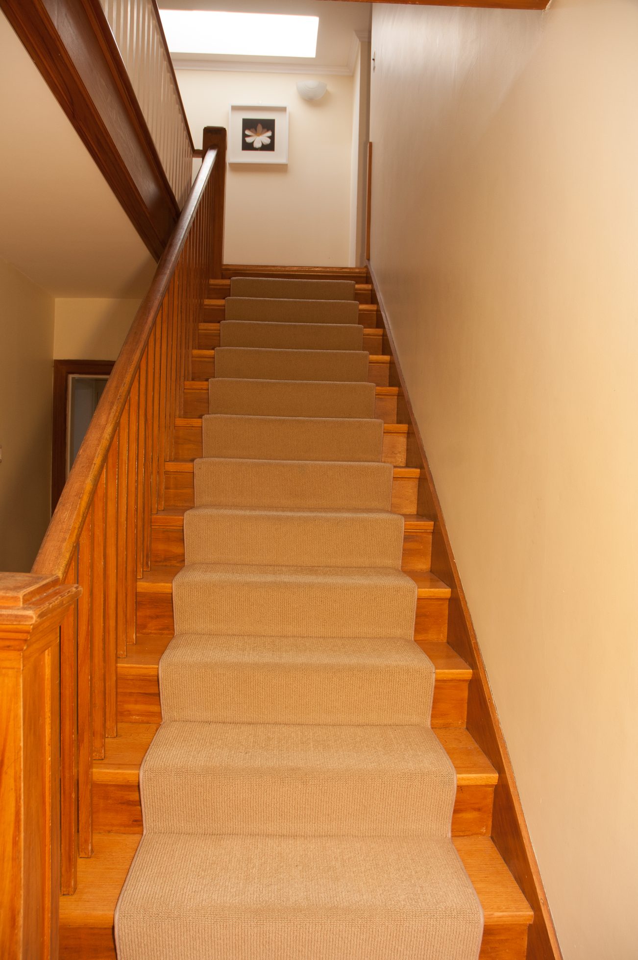 Staircase with wooden banister and carpeted steps leading up. - 3249 West 36th Ave, Vancouver West Side