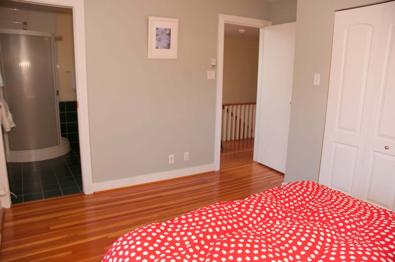 Bright bedroom with hardwood floors and red polka dot bedding. - 3249 West 36th Ave, Vancouver West Side