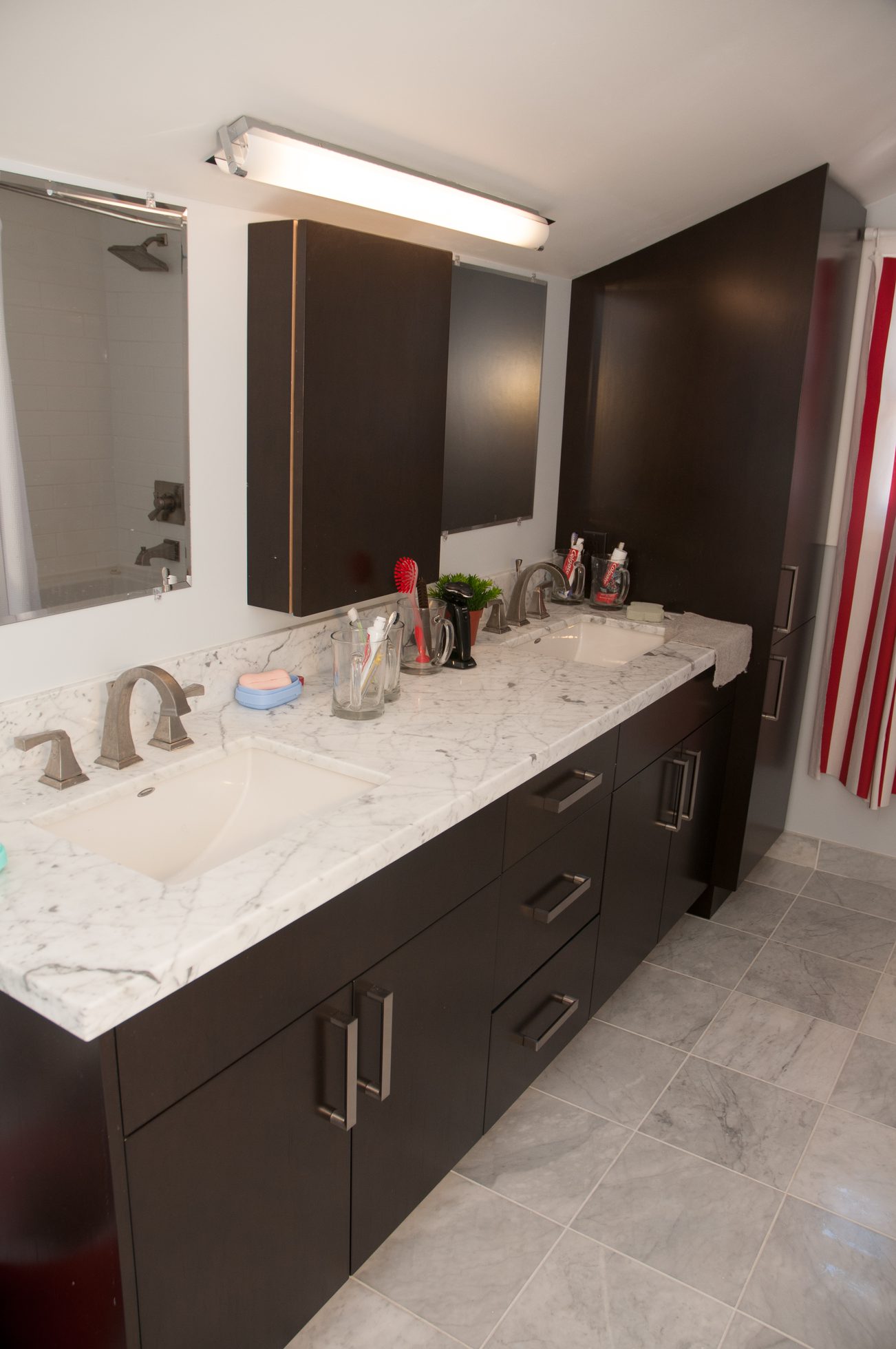 Double sink bathroom with marble countertops and dark cabinets. - 3249 West 36th Ave, Vancouver West Side