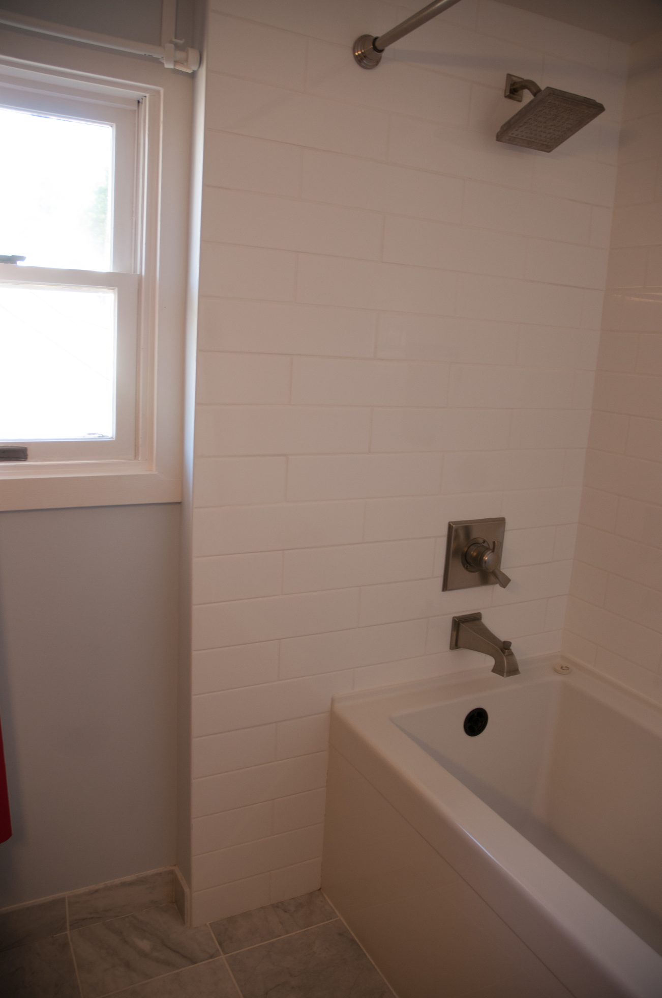Bathroom with white subway tile, modern fixtures, and a window. - 3249 West 36th Ave, Vancouver West Side
