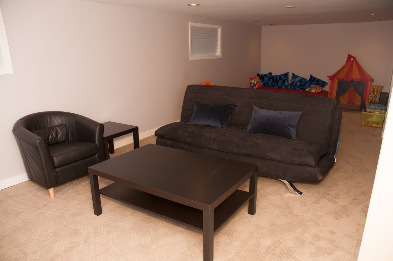 Living room with modern furniture, carpeted floor, and children's play tent. - 3249 West 36th Ave, Vancouver West Side