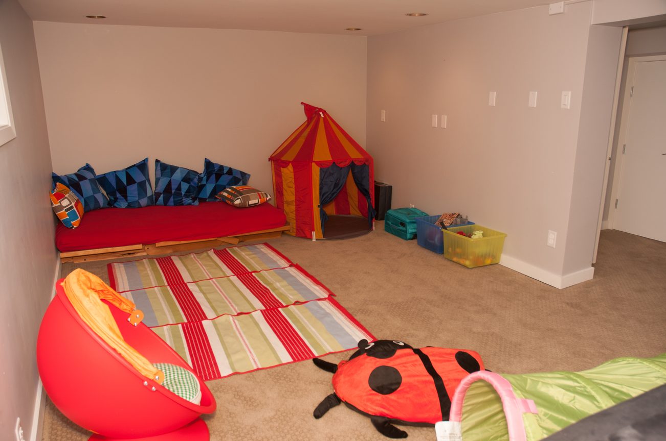 Bright playroom with colorful toys, a tent, and a ladybug slide. - 3249 West 36th Ave, Vancouver West Side