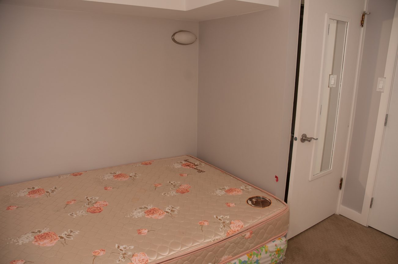 Small bedroom with floral mattress covers and white walls. - 3249 West 36th Ave, Vancouver West Side