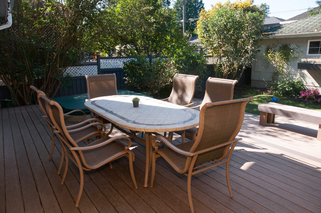 Furnished outdoor dining area with a round table and eight chairs on a wooden deck. - 3249 West 36th Ave, Vancouver West Side