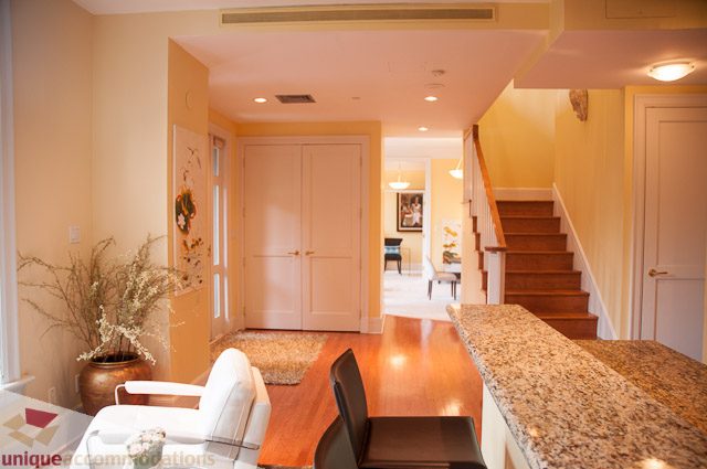 Furnished living room with granite countertops and hardwood floors. - 103-2288 Bellevue Ave, West Vancouver