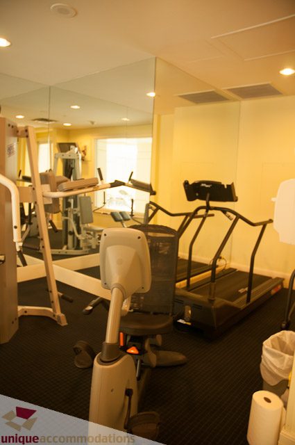 Furnished fitness room with cardio equipment and mirrors. - 103-2288 Bellevue Ave, West Vancouver