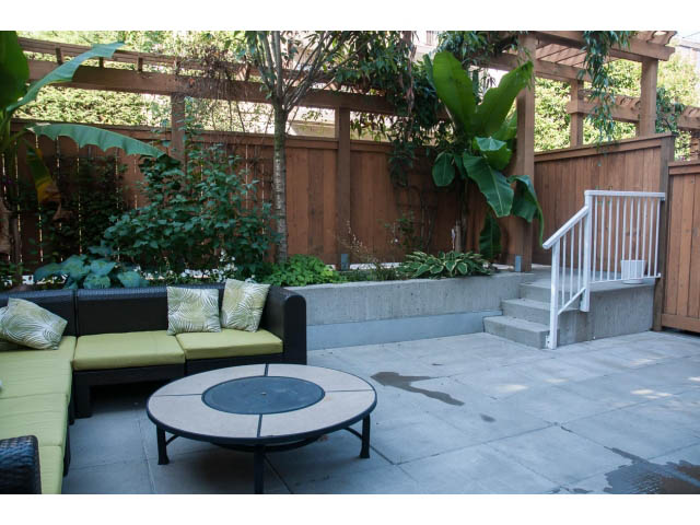Furnished patio with outdoor seating, plants, and a fire pit. - 204 - 122 East 3rd Street, North Vancouver
